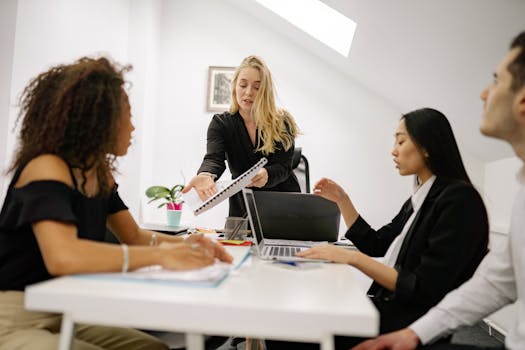 Diverse team engaged in a business meeting, collaborating and discussing ideas.