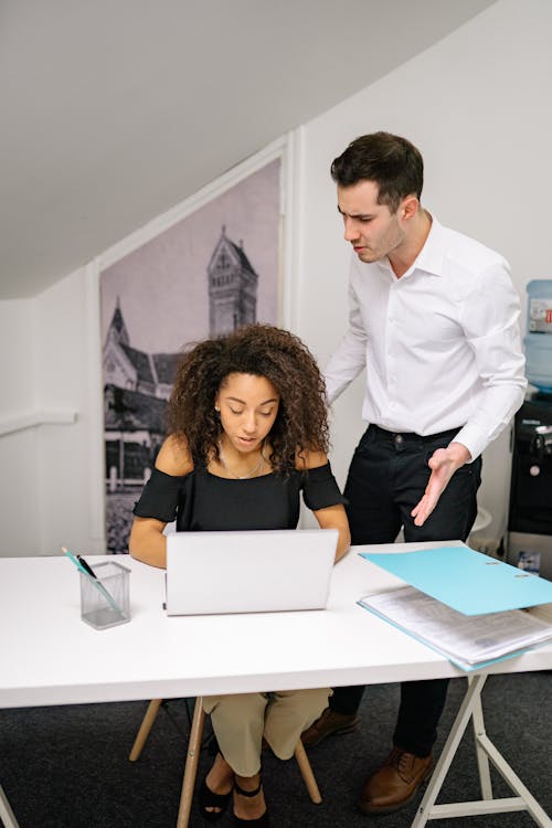 Free A Woman and Man Working in the Office Together  Stock Photo