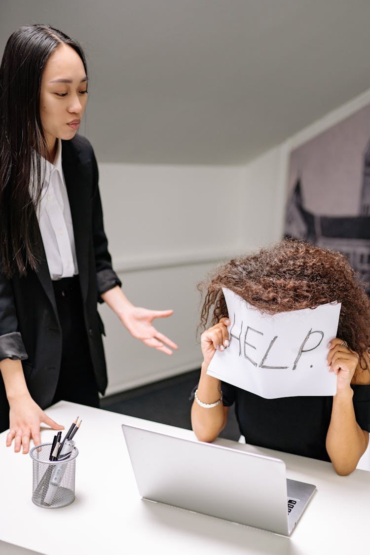 A Woman Holding A Help Sign