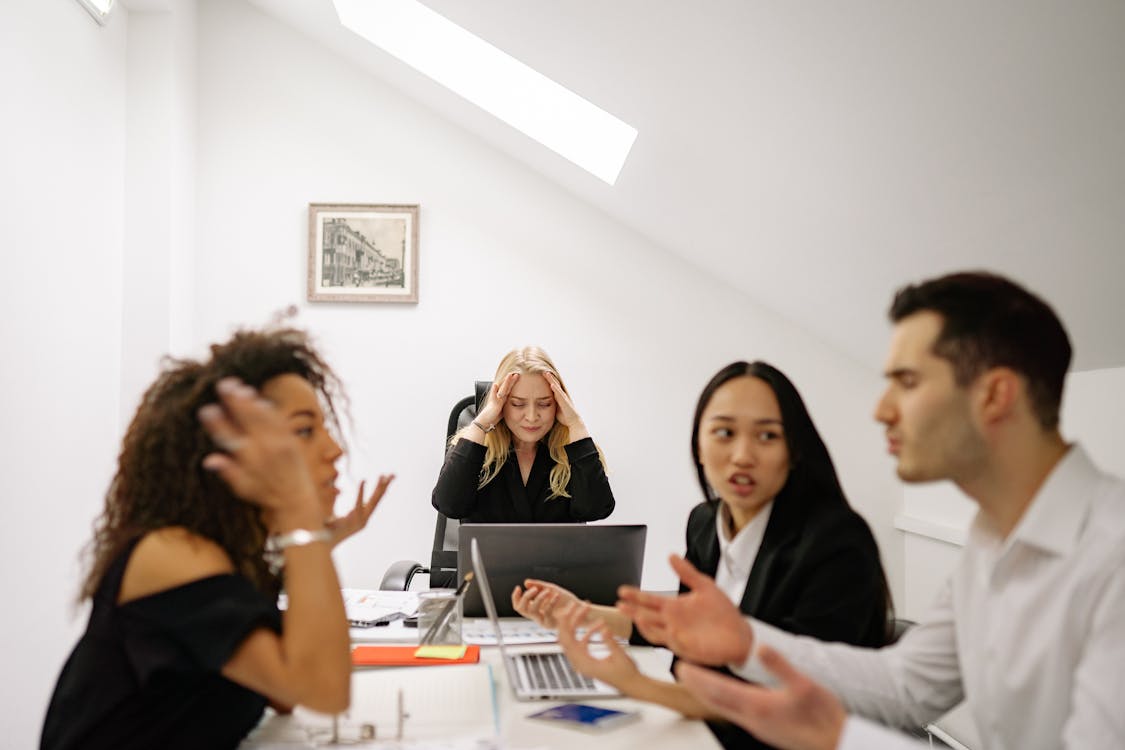 Free People having Conflict while Working Stock Photo