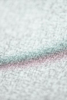 Detailed macro shot of a textured fabric showcasing a woven pattern with subtle colors and intricate design.