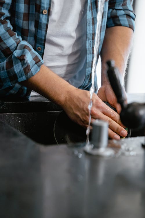 A Person Washing a Plate