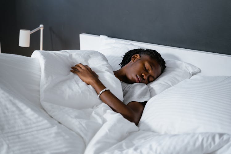 A Man Sleeping On The Bed