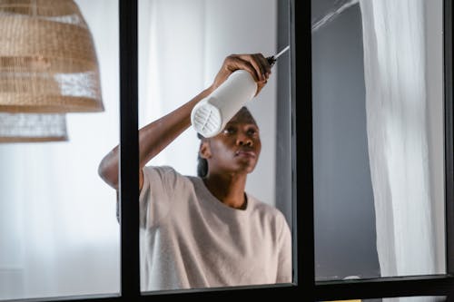 A Woman Cleaning the Window