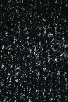 Close-up of a textured dark fabric surface, ideal for use as a background or wallpaper.