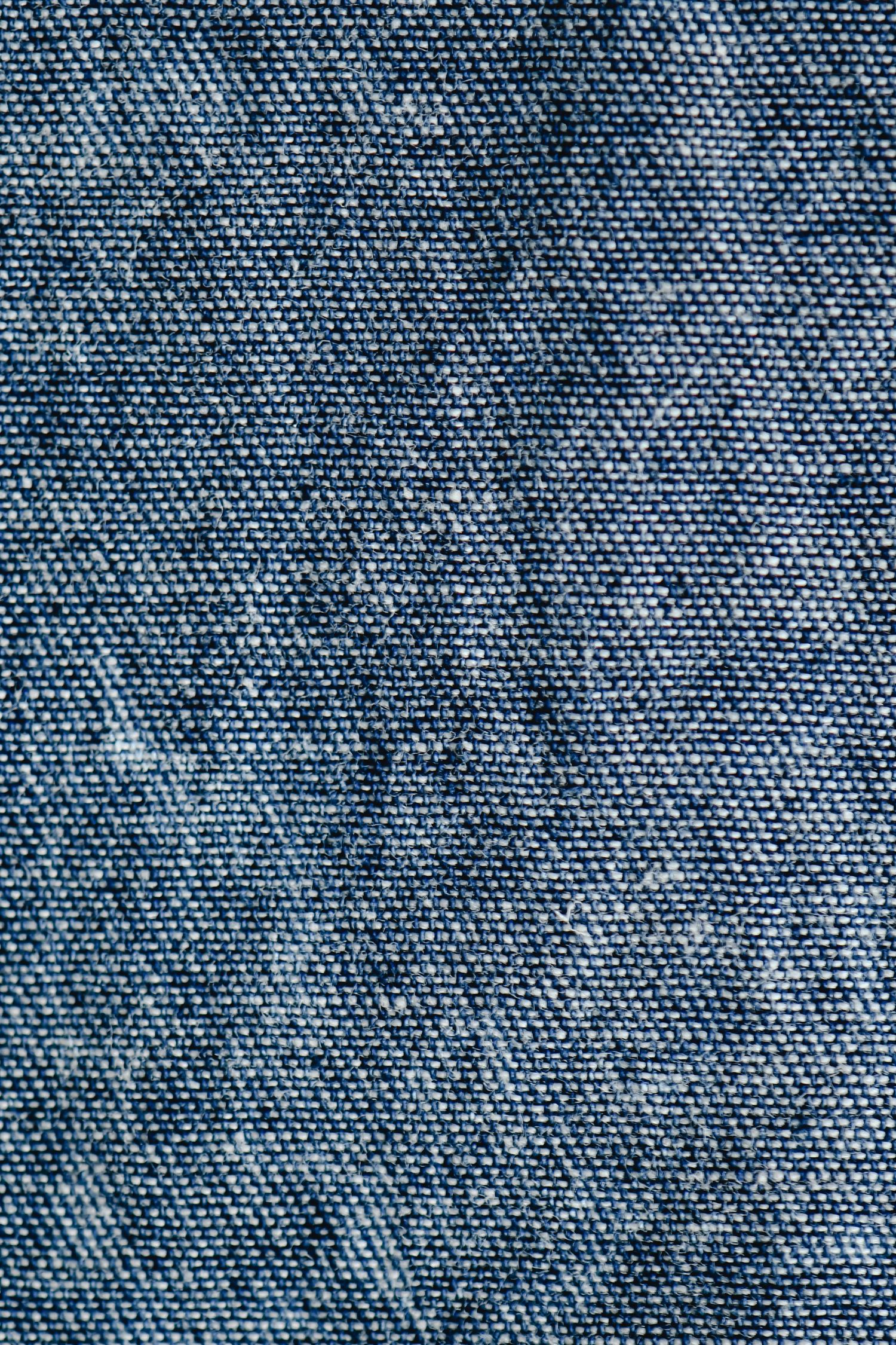 Close-up of blue denim fabric showing the diagonal twill structure