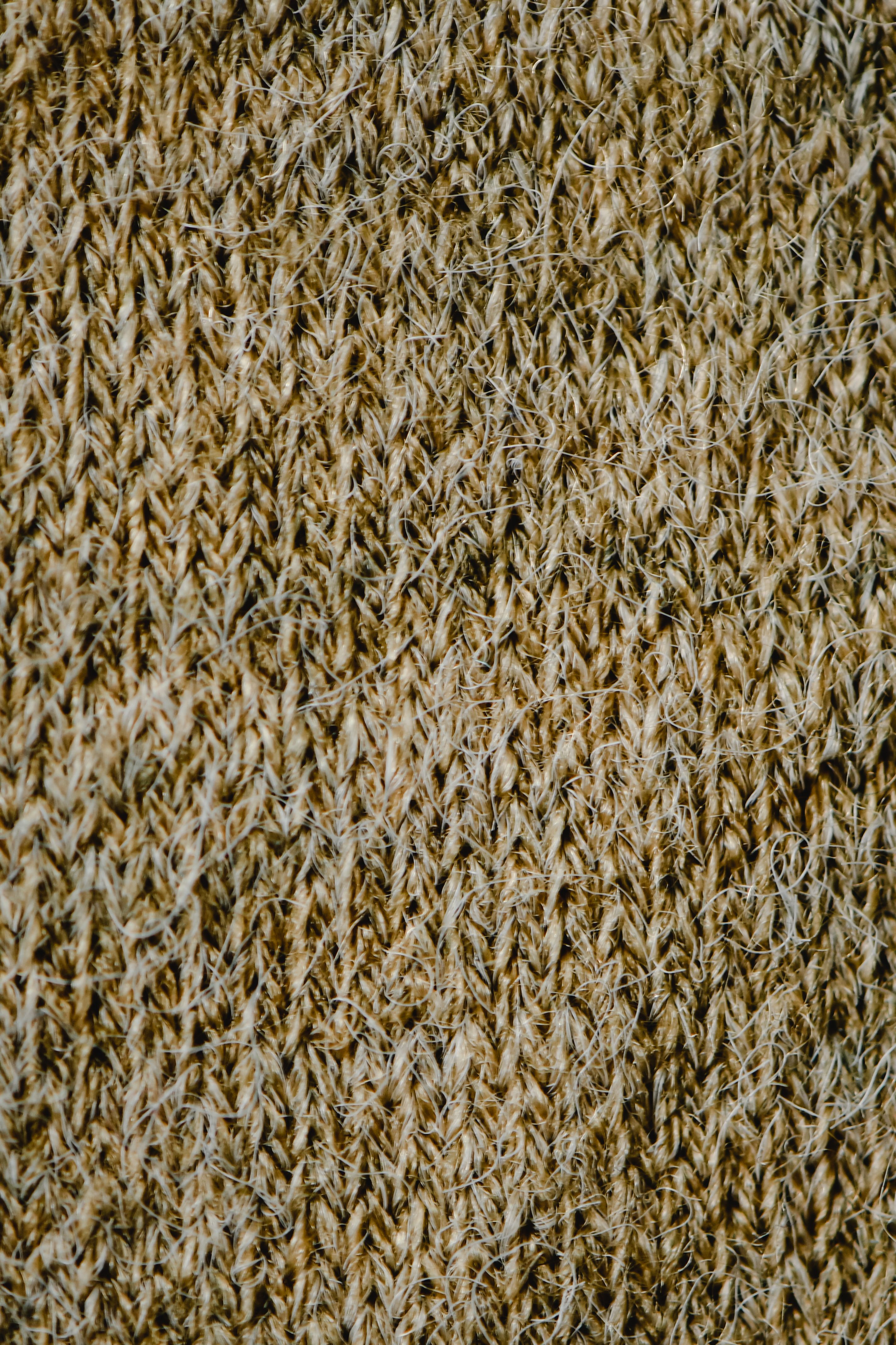 Detailed vertical close-up of a natural jute weave showing intricate patterns and fibers.