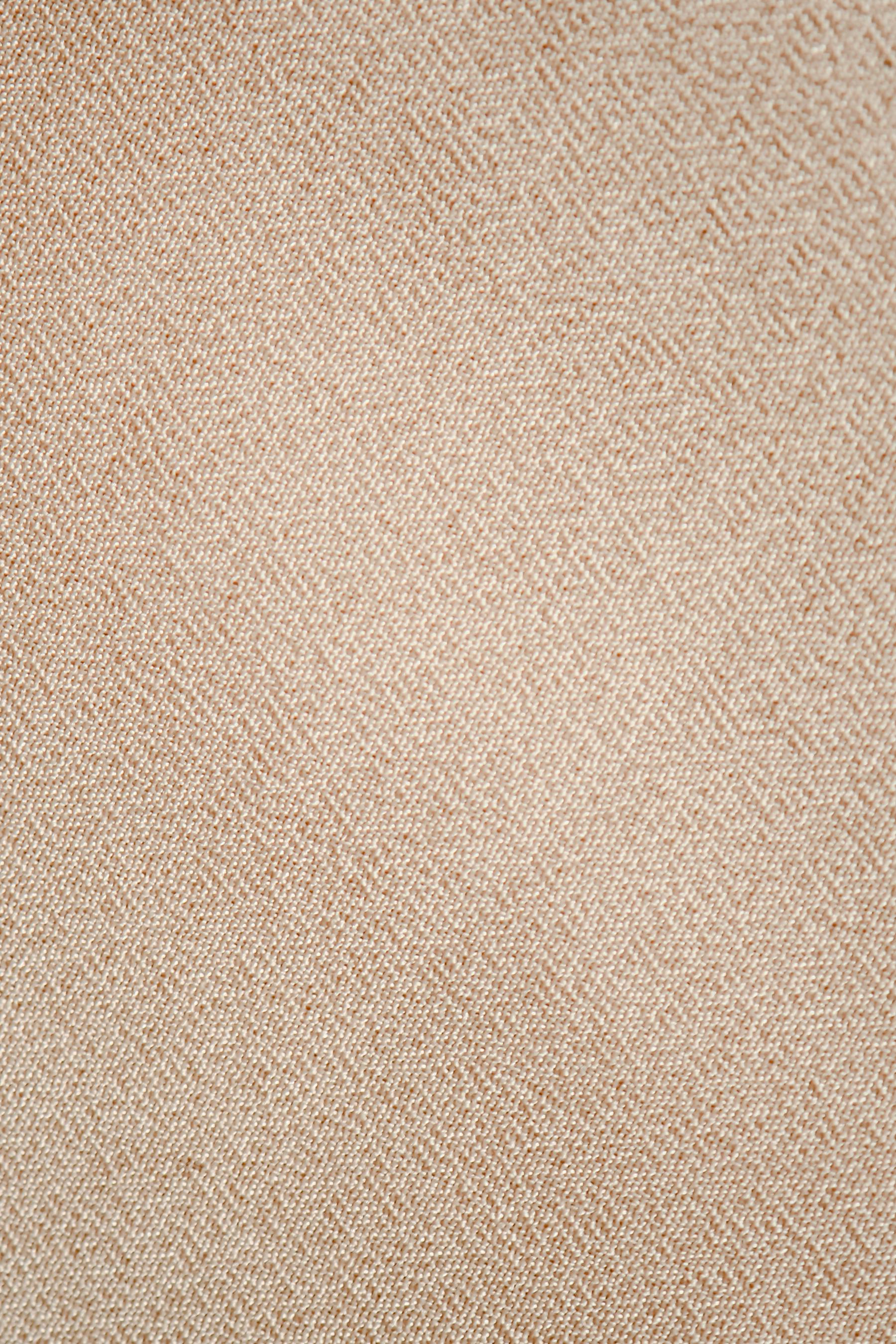 Close detail of beige linen cloth, its weave precise and calm