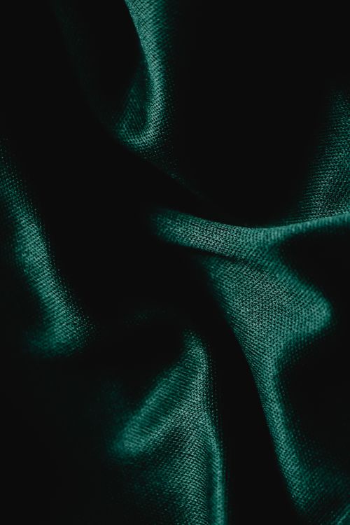 Free Detailed close-up of creased green fabric, showcasing intricate texture and shadows. Stock Photo