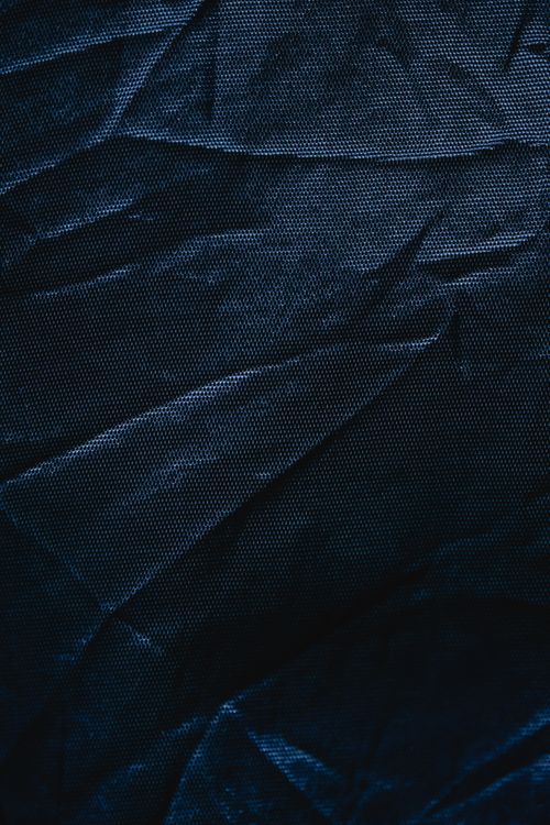 Free Detailed close-up of creased dark blue textile fabric, ideal for backgrounds and design elements. Stock Photo