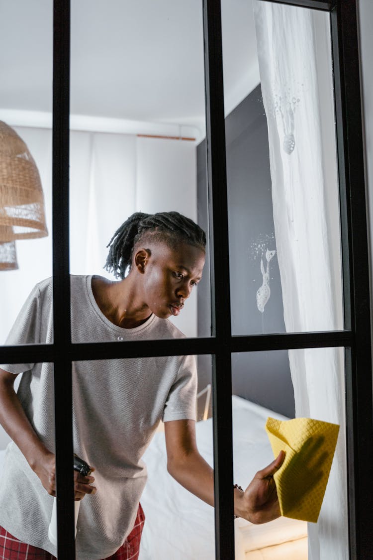 Man Wiping The Window Glass