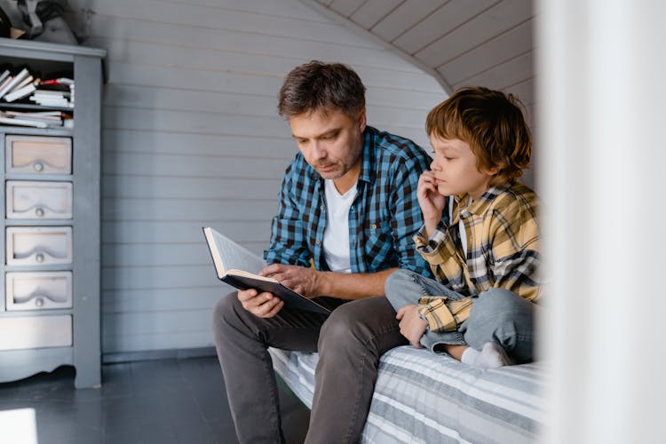 A Father Trading Book To His Boy