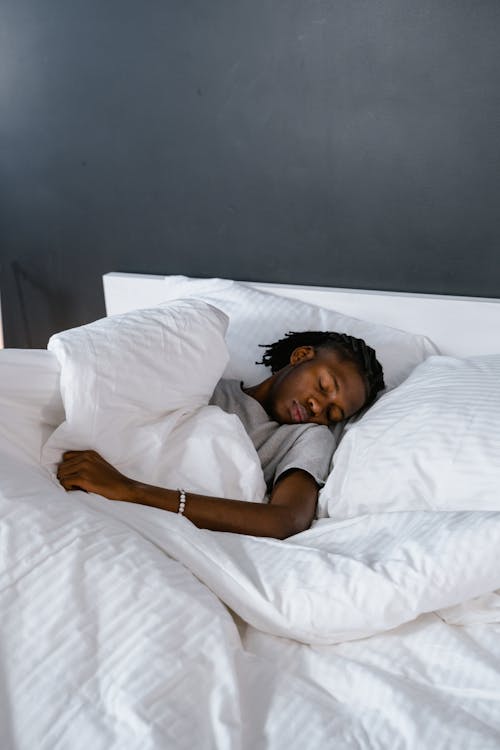 Free A Man Sleeping on the Bed Stock Photo