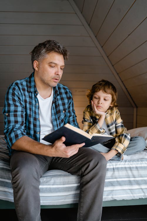 A  Father Reading a Book to His Son