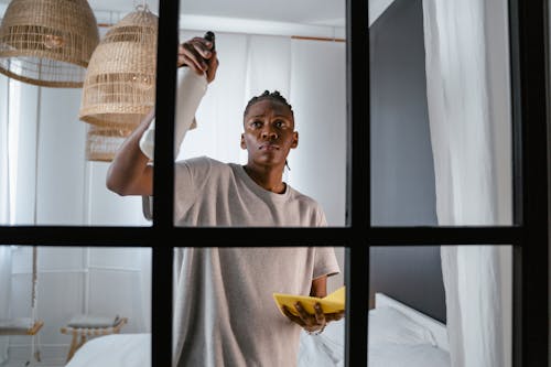 A Man Cleaning a Window from the Inside