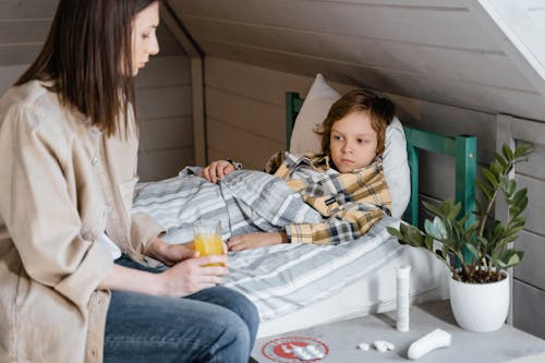 Mother sitting beside sick Child