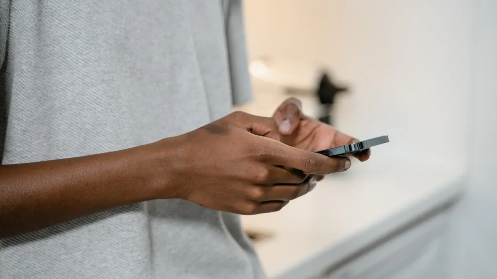 Close-up of hands texting on a smartphone