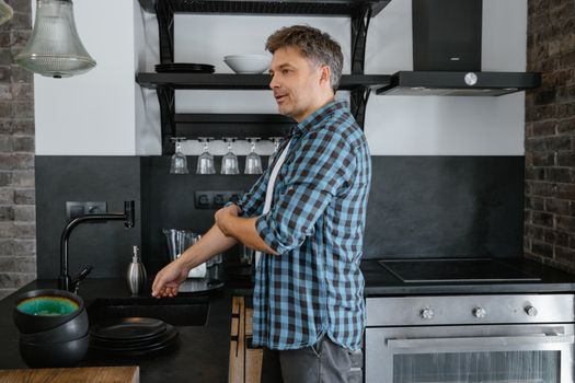 person smiling in organised kitchen