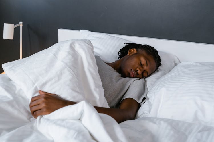 A Man Sleeping In The Bed