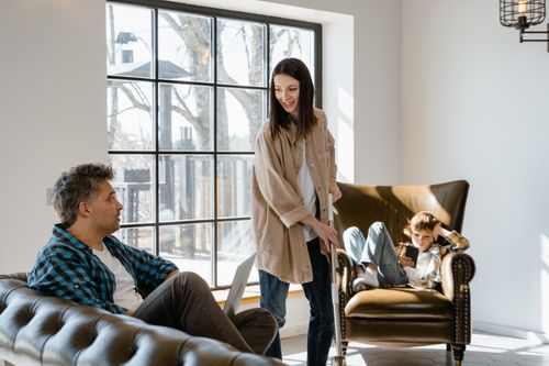 Free Happy family spending quality time in the living room with natural light. Stock Photo