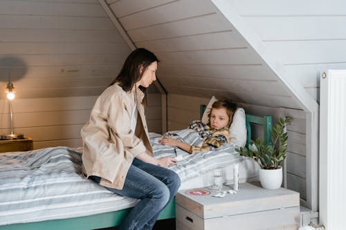 Worried Mother Takes Care of Sick Child 