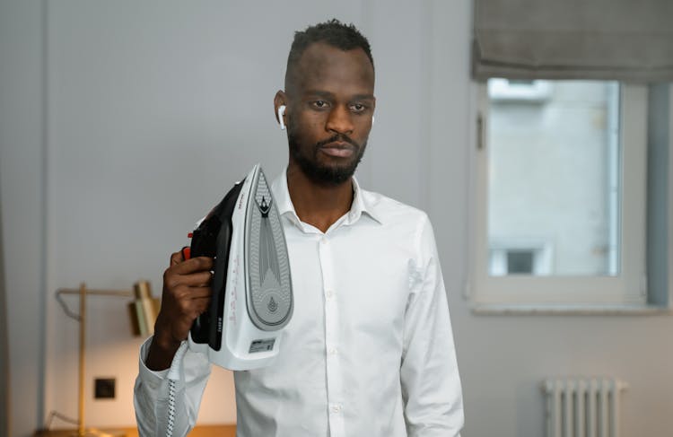 Man In White Dress Shirt Holding An Iron 