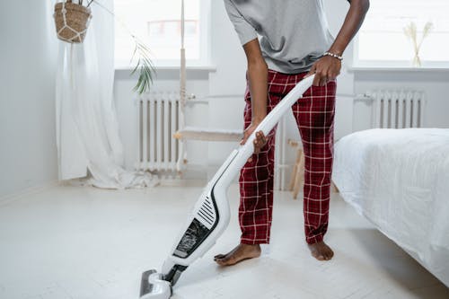 Free Man in Gray T-shirt Using Vacuum Cleaner Stock Photo