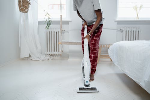 Barefoot Man Using Vacuum Cleaner