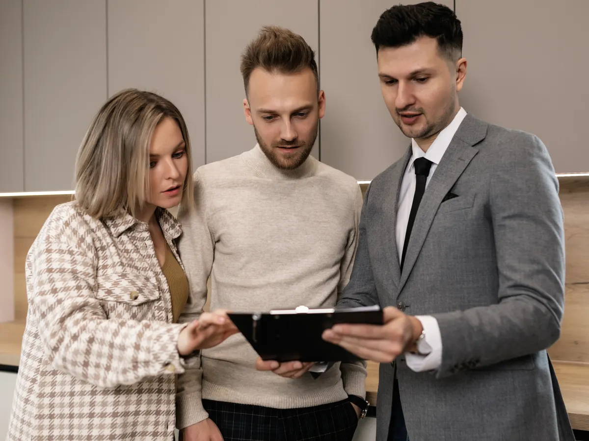 A lawyer reviewing real estate documents with a client. Alt text: A property lawyer provides legal advice for property transactions.