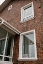 A contemporary brick-faced residential home with a 'sold' sign in the window.