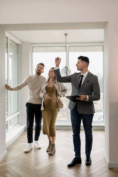 Free Real Estate Agent Showing Property to a Couple Stock Photo