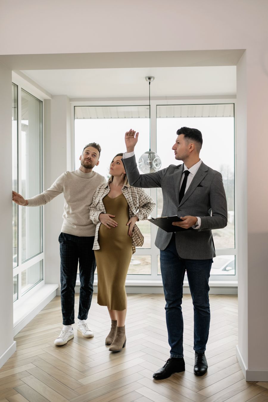 Real estate agent showing a property to buyers
