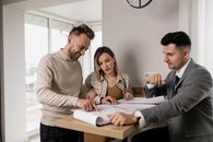 Man and Woman Standing near Brown Wooden Table
