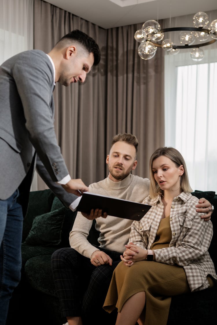 A Real Estate Agent Negotiating With A Couple