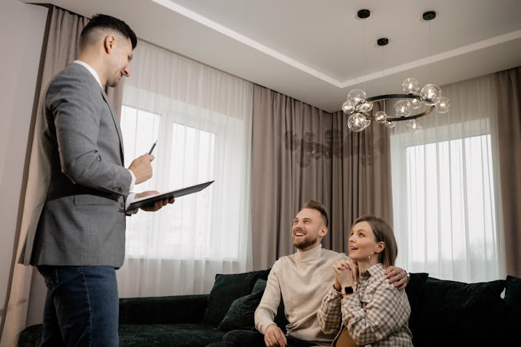 Person In Gray Suit Jacket Talking To Clients