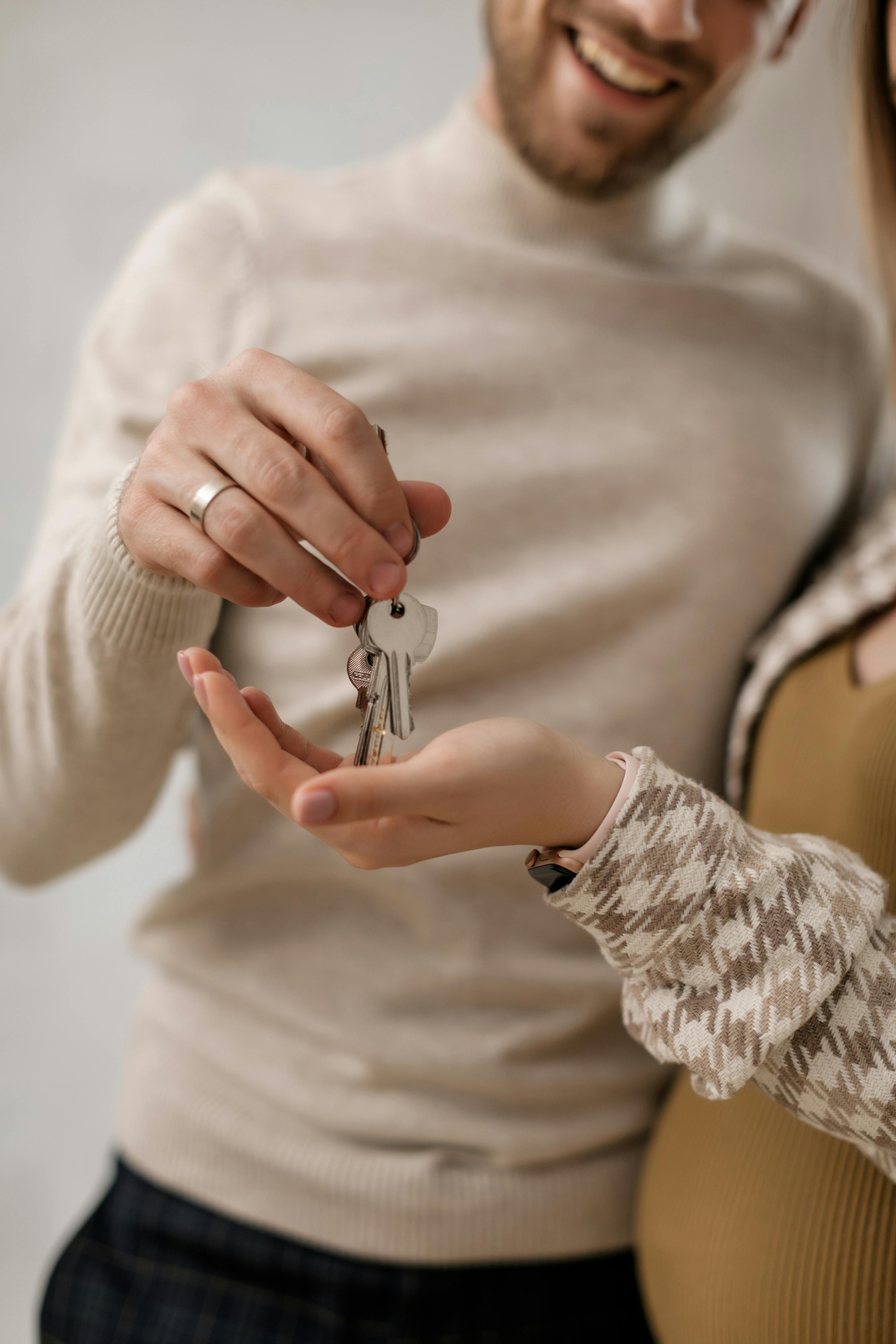 man giving keys to a woman