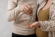 A Couple Holding the Keys for a New House