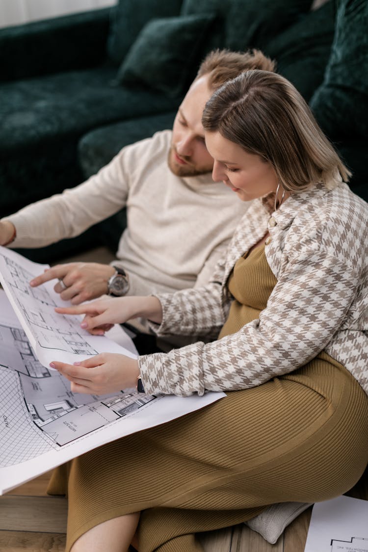 Couple Looking At A Blueprint