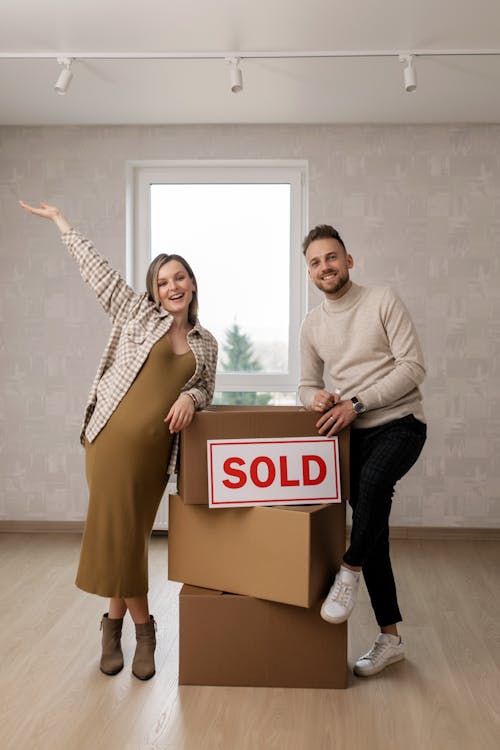 Free 
A Couple Leaning on a Stack of Boxes Stock Photo