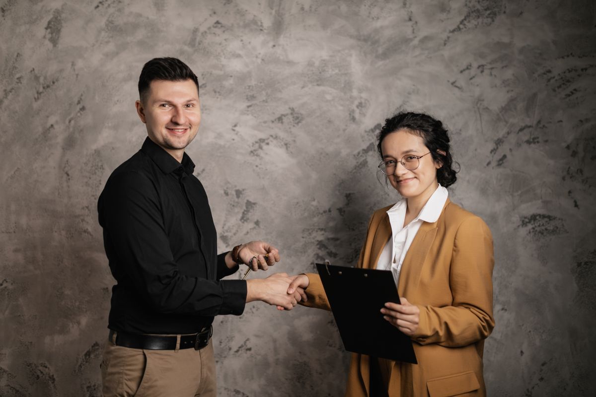 Property professional meeting with a client and holding keys.