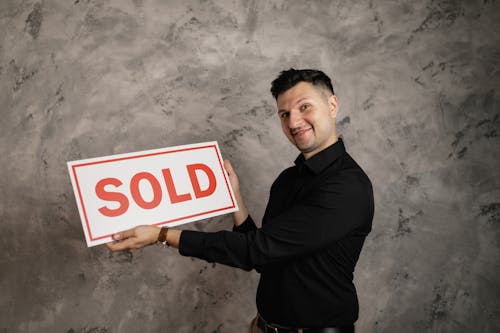 Man Holding a Signboard Smiling