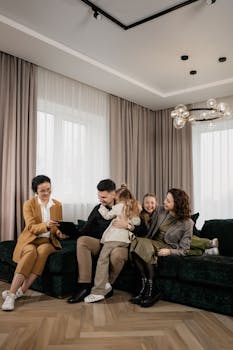 A joyful family consults with a real estate agent in their modern living room.