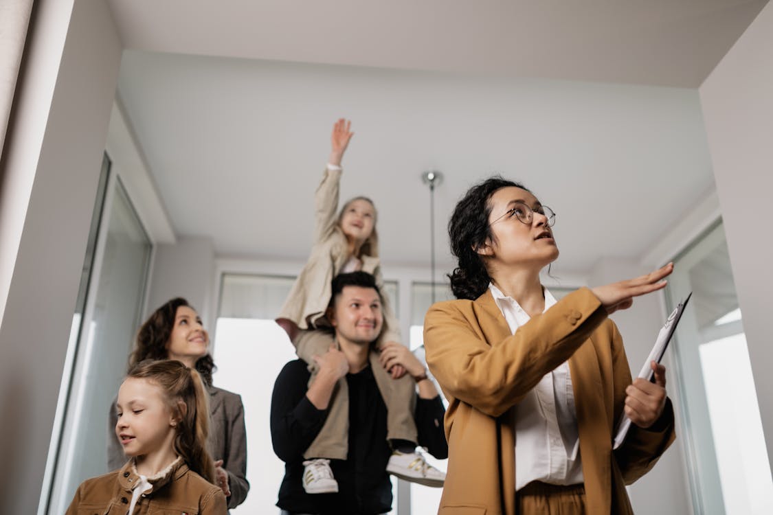 Free A Realtor with a Family in a House Viewing Stock Photo