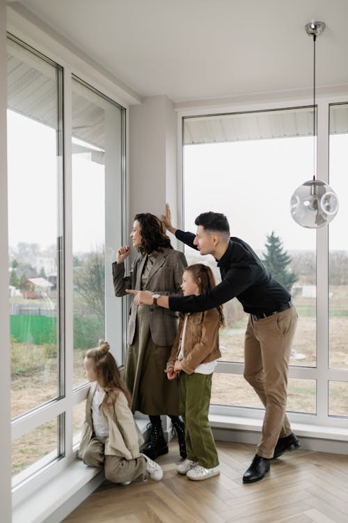 A Family Looking Out the Window