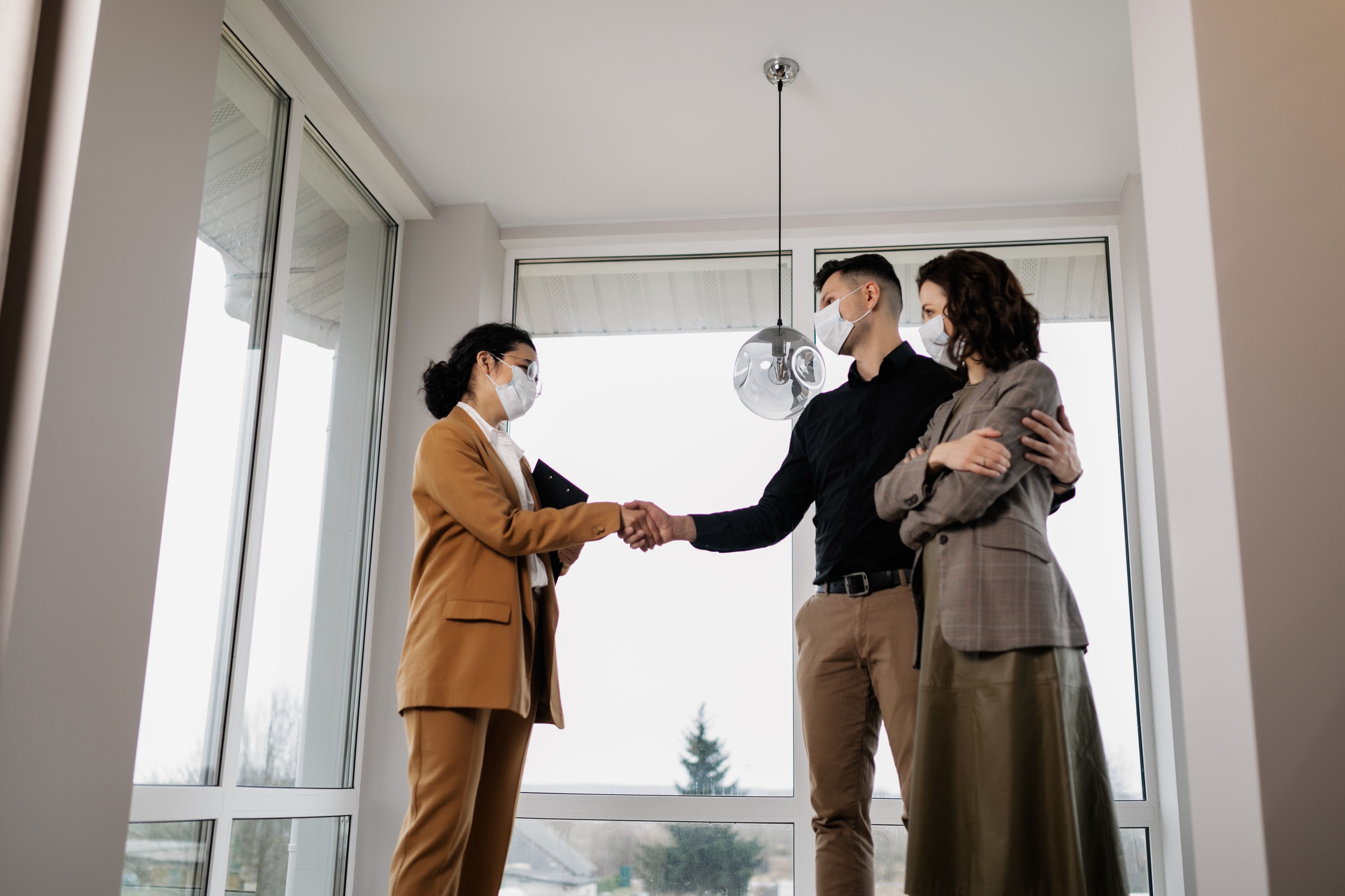 Homebuyer shaking hands with a real estate professional after a successful consultation