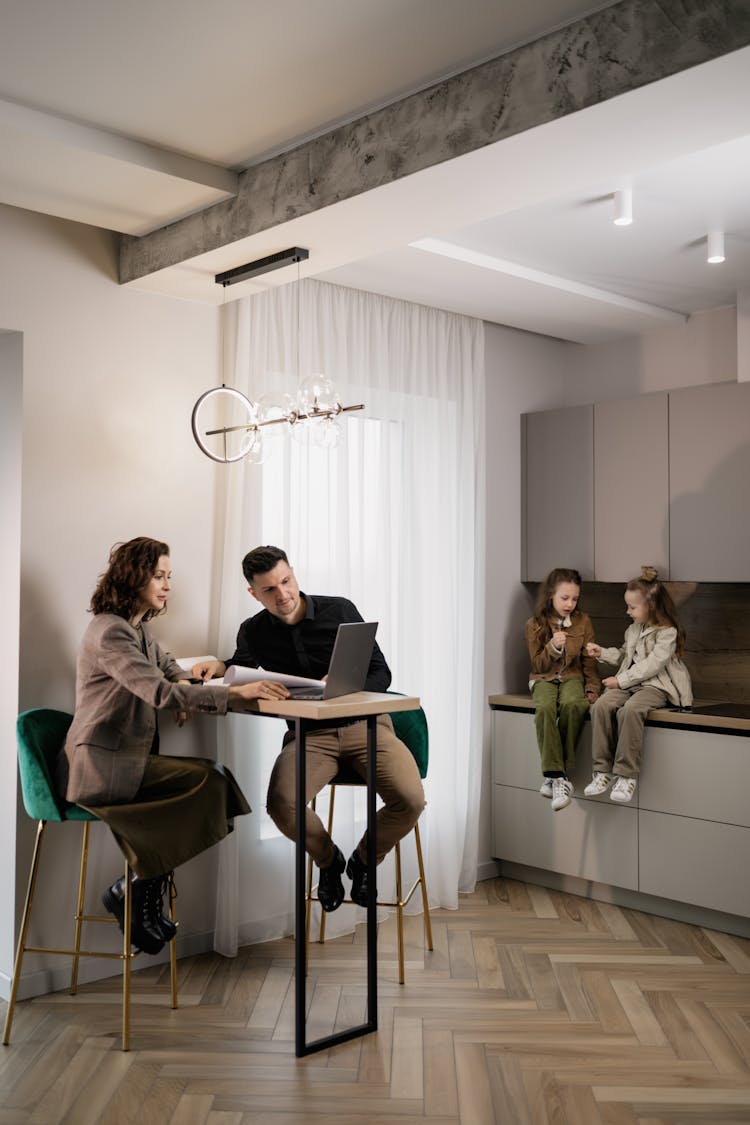 
A Couple Looking At Documents While Sitting