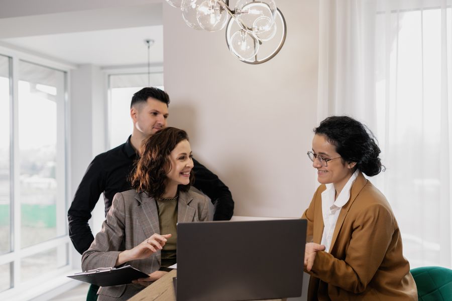 Real estate professionals discussing lead management in a modern office