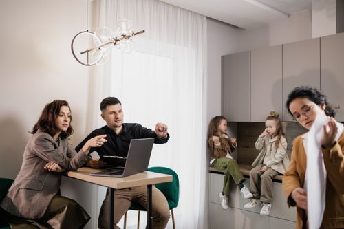Free Family discussing real estate purchase inside home with agent and children present. Stock Photo