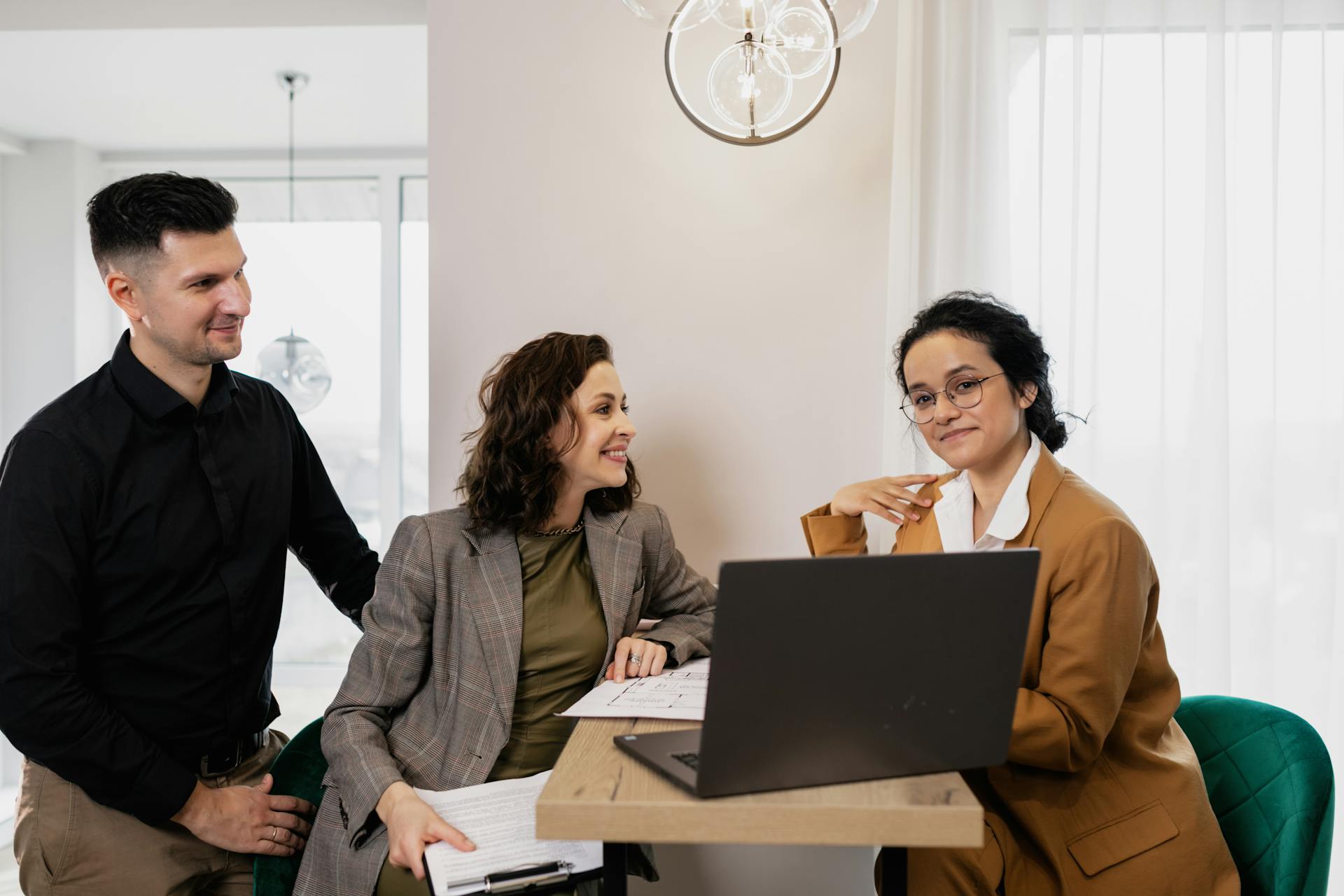 A Man and a Woman Sitting at the Table with a Consultant