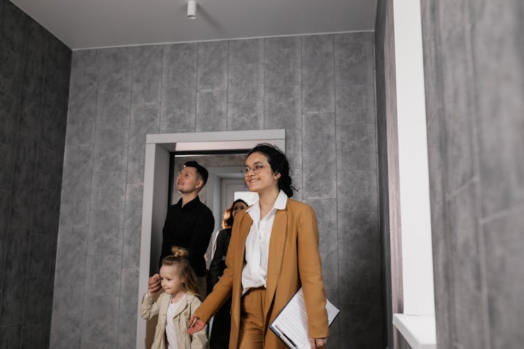 Real Estate Agent Showing A House To A Family 